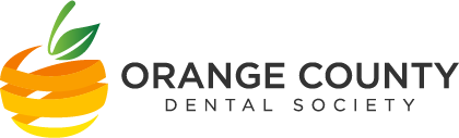 The image shows a logo with text that reads  ORANGE COUNTY DENTAL SOCIETY  and includes an illustration of a stylized orange with a leaf on top, suggesting a connection to the name and possibly indicating a theme related to the locality or industry.